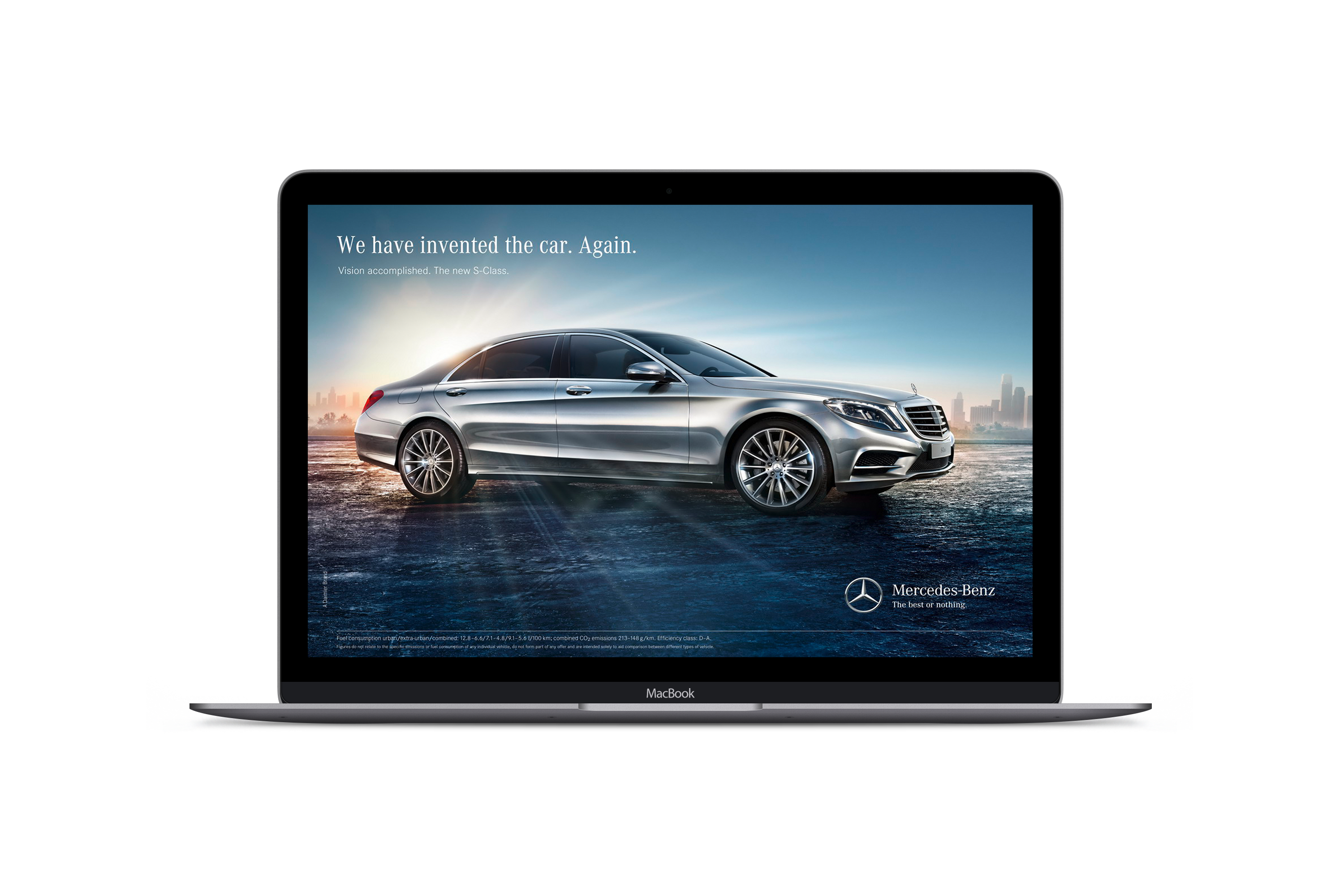 How to Craft your Buyer Personas Blog. This is an image of a MacBook Pro laptop opened up and displaying an advert for a Mercedes Benz car. In the image is a Mercedes S-Class on a road with the sun shining behind it. The slogan in the sky reads "We have invented the car again". The Mercedes caption reads "All or Nothing"